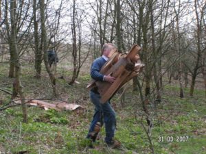 Clearing tree protectors in Carr Lane Plantation